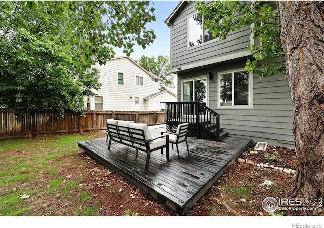 608 Bluegrass Dr, Longmont, CO 80503 - wooden terrace featuring a fenced backyard and an outdoor living space