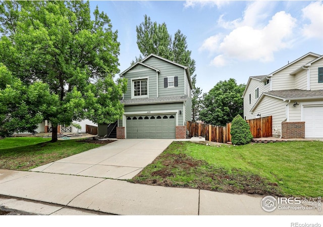 608 Bluegrass Dr, Longmont, CO 80503 - traditional home featuring an attached garage, concrete driveway, and brick siding