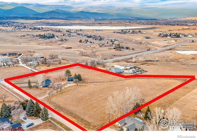 birds eye view of property with a mountain view and a rural view