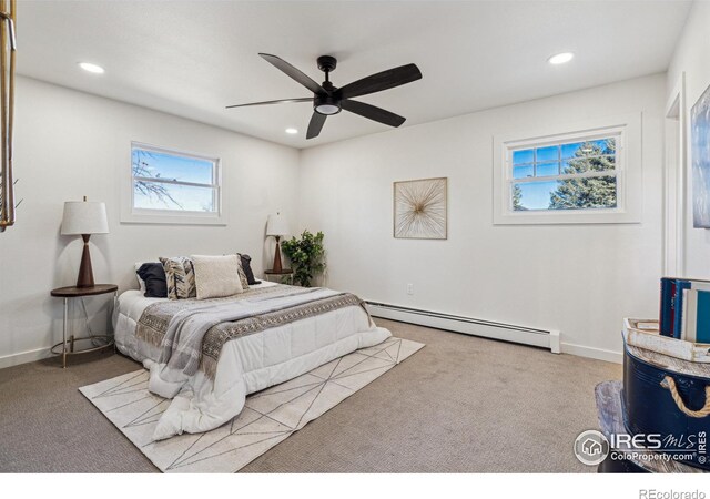 bedroom featuring ceiling fan, light colored carpet, and a baseboard radiator