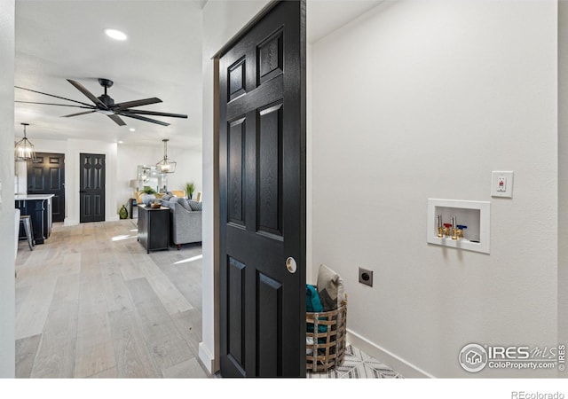 washroom featuring light hardwood / wood-style floors, ceiling fan, washer hookup, and hookup for an electric dryer