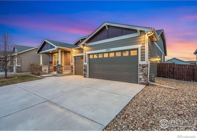 view of front of property featuring central AC unit and a garage