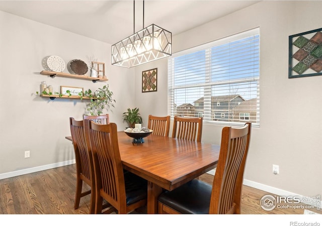 dining space with dark hardwood / wood-style flooring