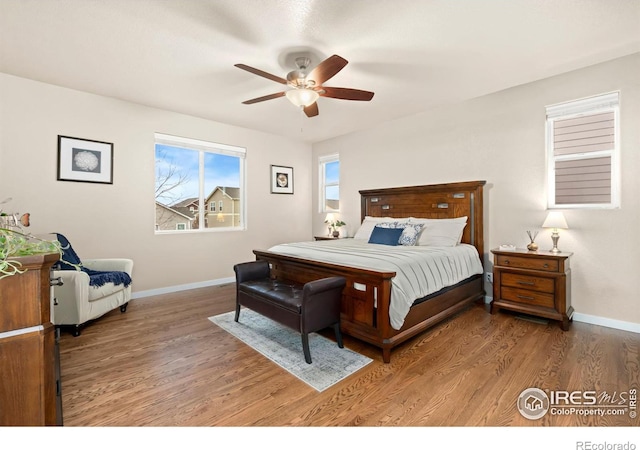 bedroom with hardwood / wood-style floors and ceiling fan