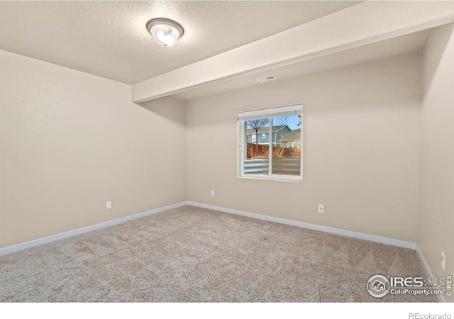 unfurnished room featuring a textured ceiling and carpet floors