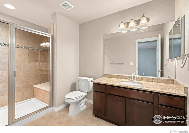 bathroom featuring tile patterned floors, vanity, walk in shower, and toilet