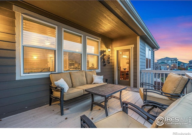 deck at dusk with an outdoor hangout area