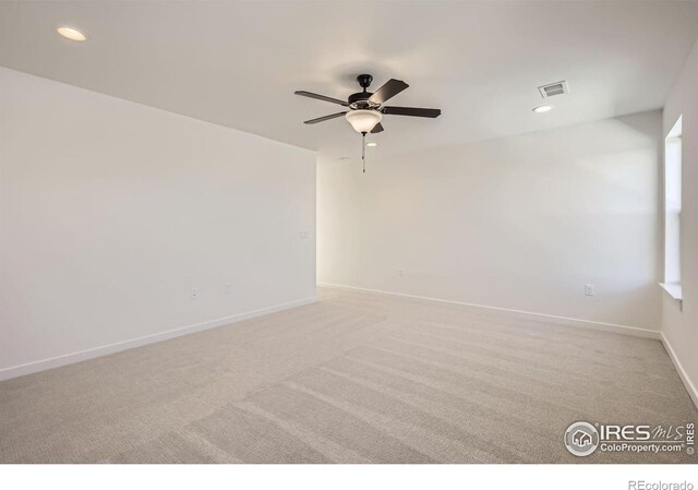 unfurnished room featuring baseboards, visible vents, light colored carpet, ceiling fan, and recessed lighting