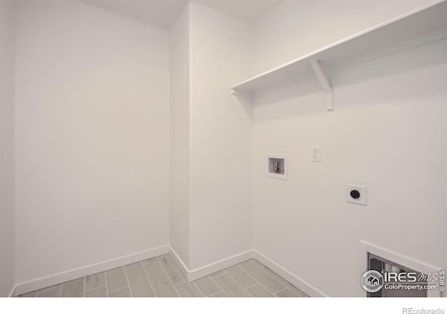 laundry area featuring hookup for a washing machine, wood tiled floor, electric dryer hookup, laundry area, and baseboards