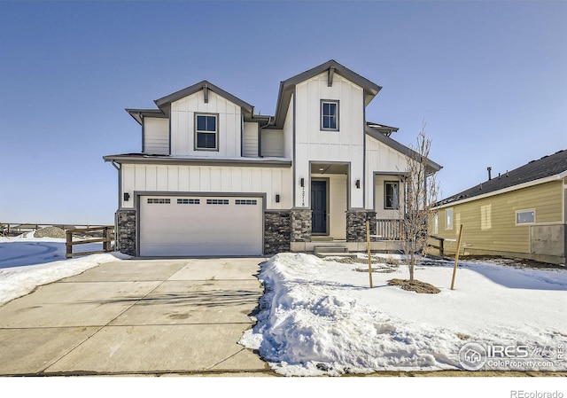 view of front facade with board and batten siding, concrete driveway, stone siding, and a garage