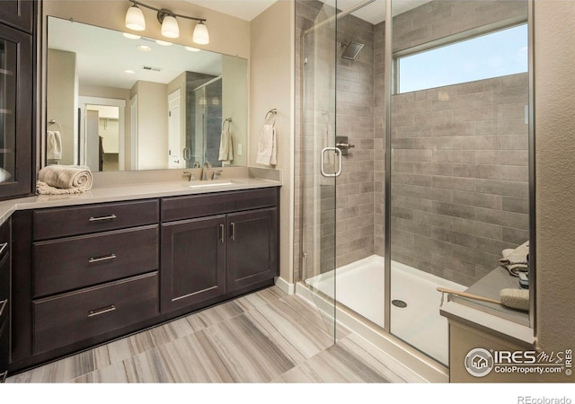 bathroom with vanity and walk in shower