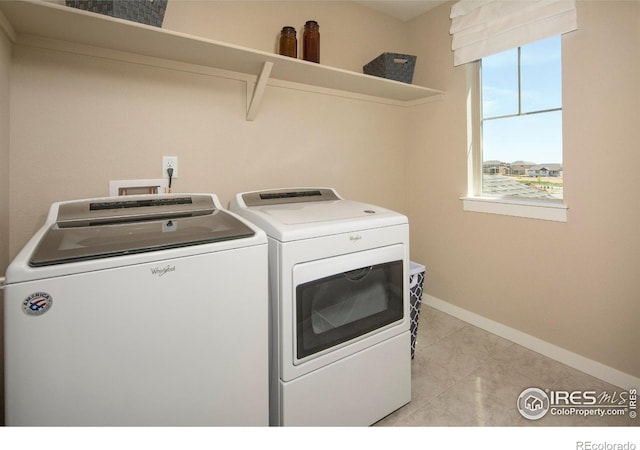 clothes washing area with washer and clothes dryer