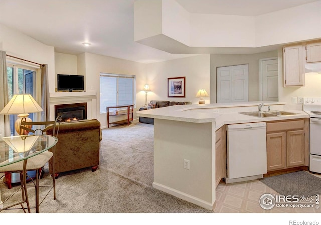 kitchen with kitchen peninsula, white appliances, light colored carpet, extractor fan, and sink