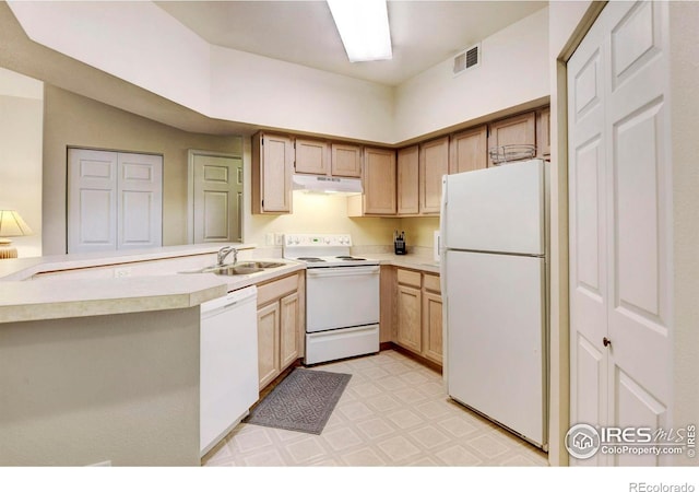 kitchen with kitchen peninsula, light brown cabinets, white appliances, and sink