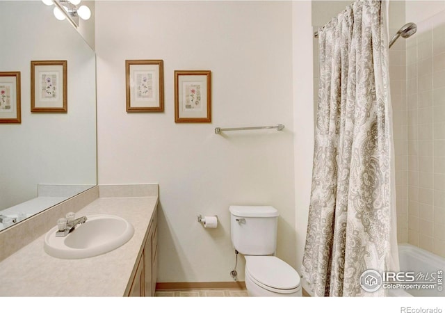 bathroom featuring tile patterned flooring, vanity, and toilet