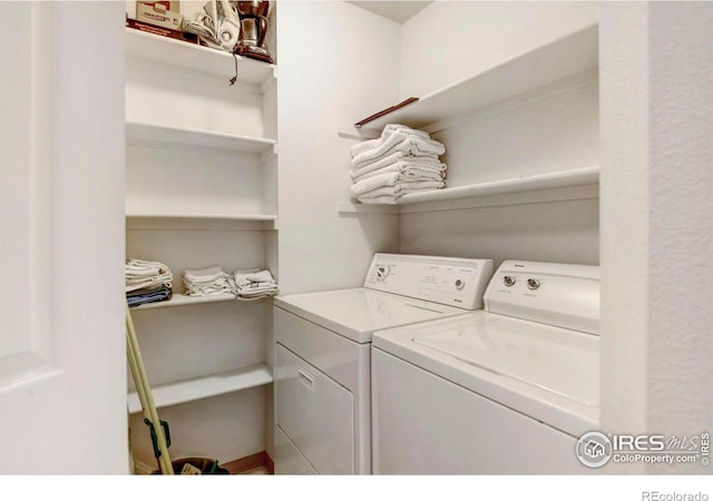 clothes washing area with washing machine and dryer