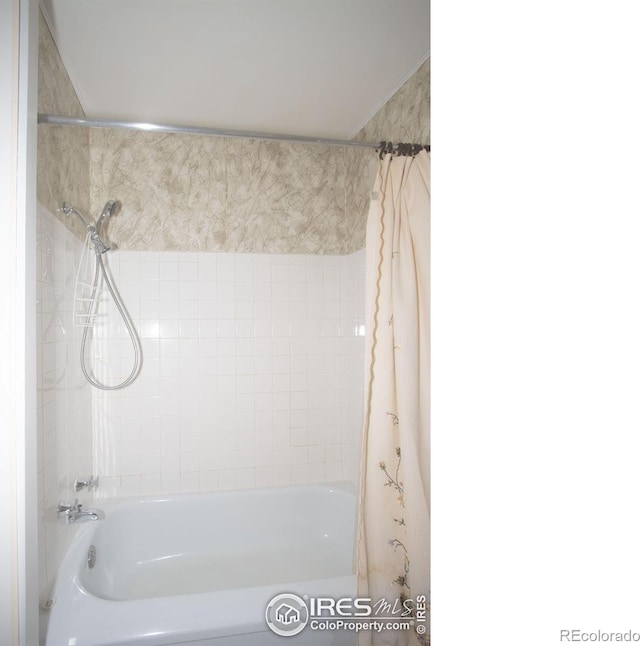 bathroom with shower / tub combo with curtain