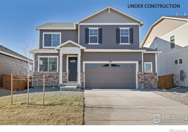 view of front of home with a front yard and a garage