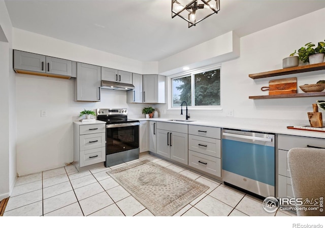 kitchen featuring light tile patterned flooring, appliances with stainless steel finishes, gray cabinetry, and sink