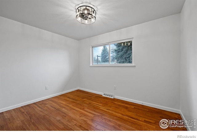 unfurnished room featuring hardwood / wood-style flooring