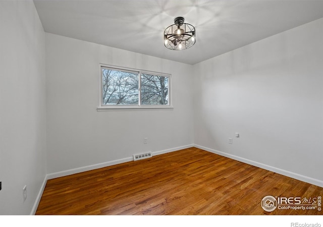 unfurnished room with hardwood / wood-style floors