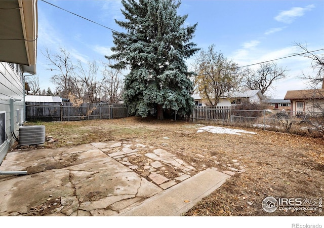 view of yard with cooling unit and a patio area