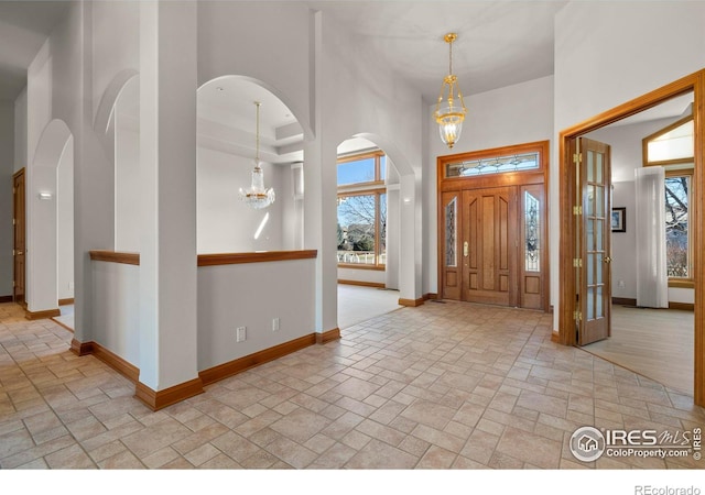 foyer with a chandelier and a high ceiling