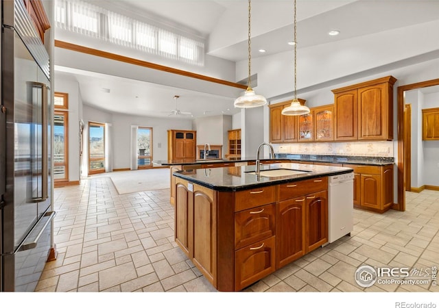 kitchen with pendant lighting, high vaulted ceiling, stainless steel built in fridge, and a healthy amount of sunlight