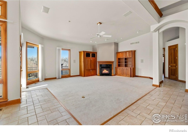 carpeted living room with vaulted ceiling and ceiling fan