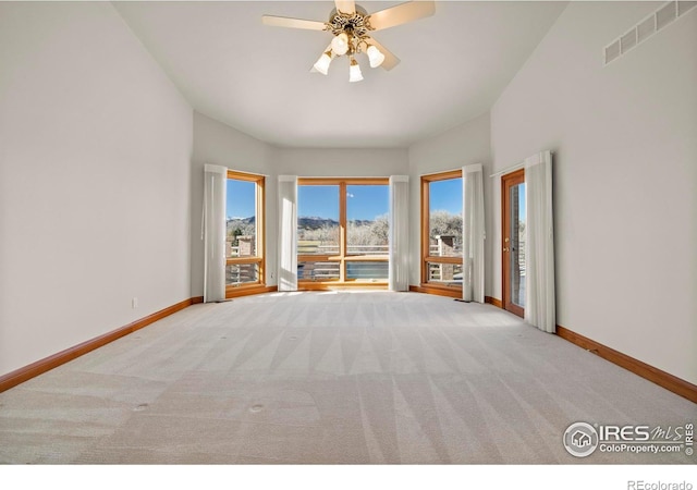 unfurnished living room featuring ceiling fan and light carpet