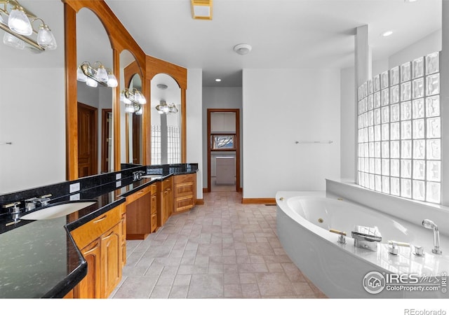 bathroom with vanity and a bath