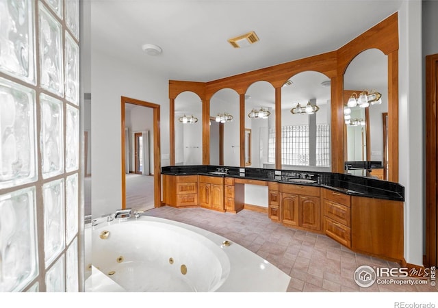 bathroom featuring vanity and a tub