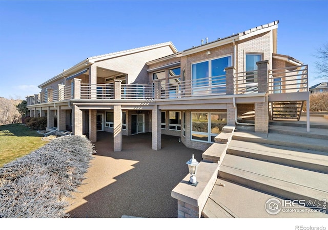 rear view of property with a balcony