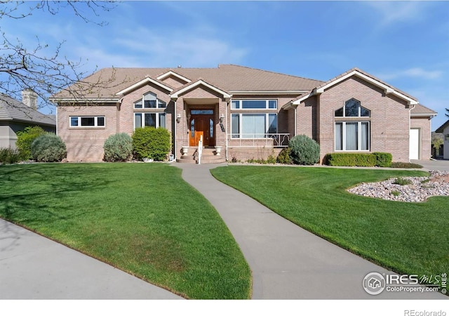 835 Rossum Dr, Loveland, CO 80537 - ranch-style home with a front yard and brick siding