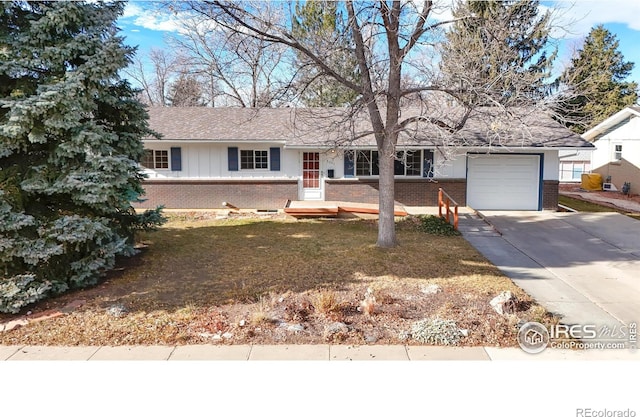 single story home featuring a front yard and a garage