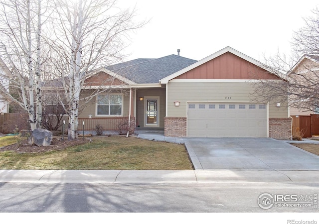 view of front of home with a garage and a front lawn