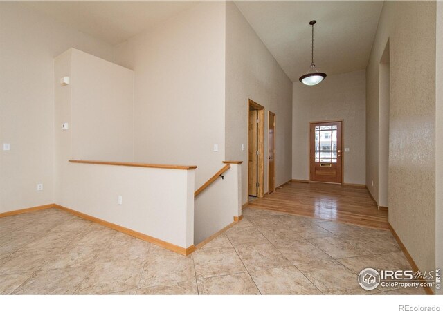 entrance foyer featuring a high ceiling and light wood-type flooring