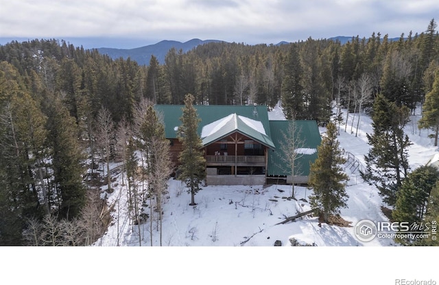 snowy aerial view featuring a mountain view