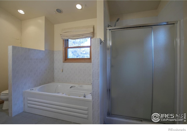 bathroom featuring tile patterned floors, independent shower and bath, tile walls, and toilet