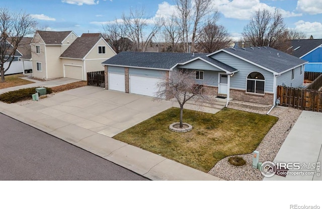 ranch-style house with a garage and a front yard