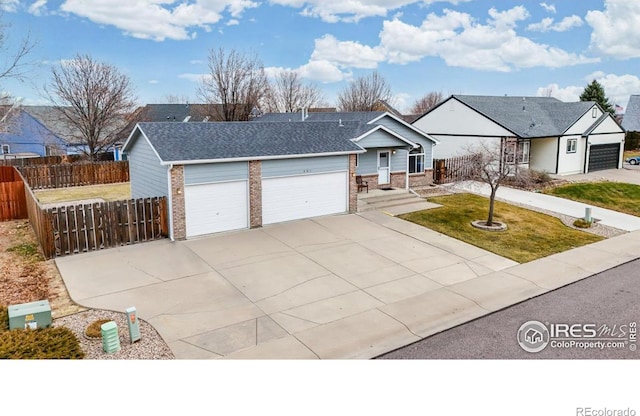 view of front of home with a garage and a front lawn