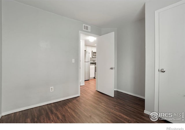 spare room featuring dark hardwood / wood-style floors