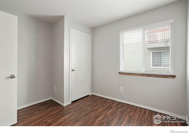 spare room with dark hardwood / wood-style floors