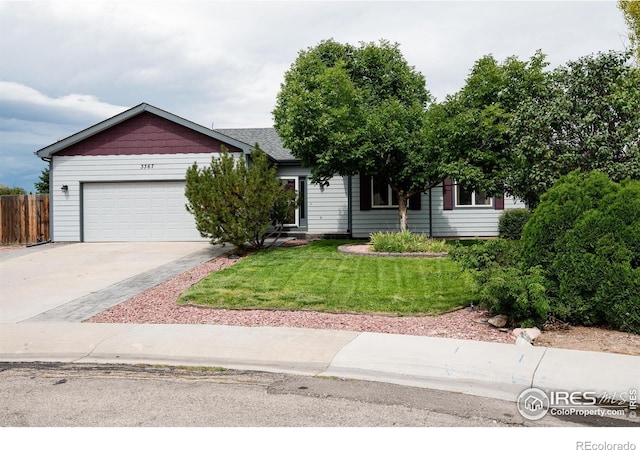 view of front of home with a front yard and a garage