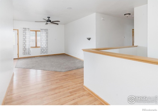 empty room featuring wood-type flooring and ceiling fan