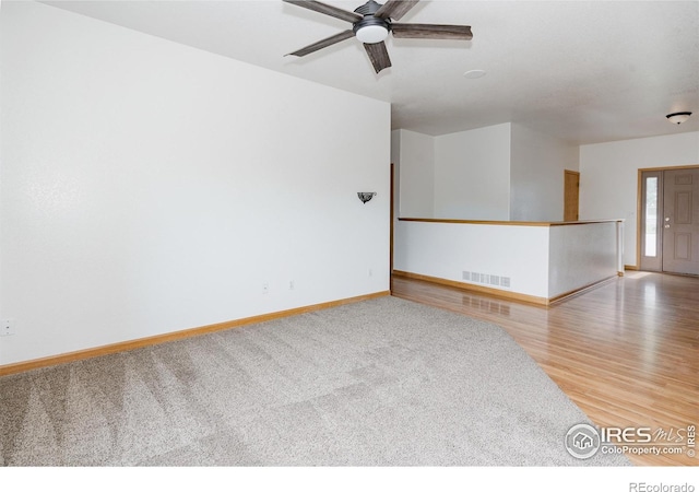 spare room featuring hardwood / wood-style flooring and ceiling fan