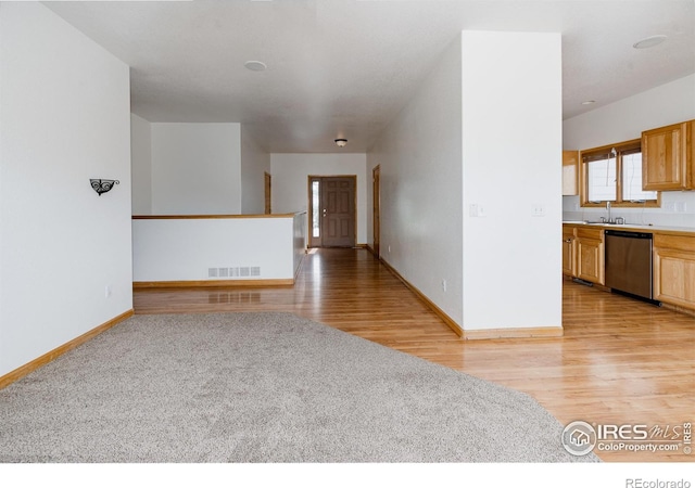 empty room with light hardwood / wood-style floors and sink