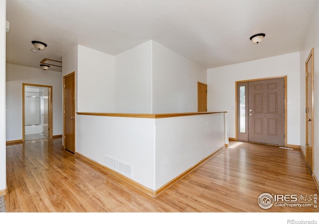 foyer entrance with light hardwood / wood-style floors