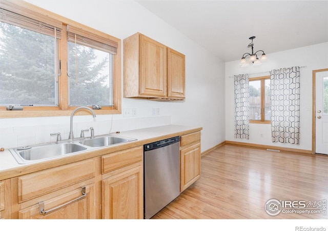 kitchen featuring dishwasher, light brown cabinets, decorative light fixtures, and a wealth of natural light