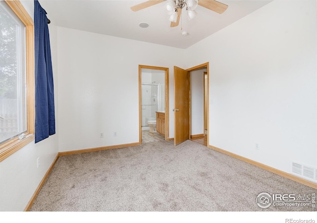 unfurnished bedroom featuring carpet flooring, ceiling fan, and connected bathroom